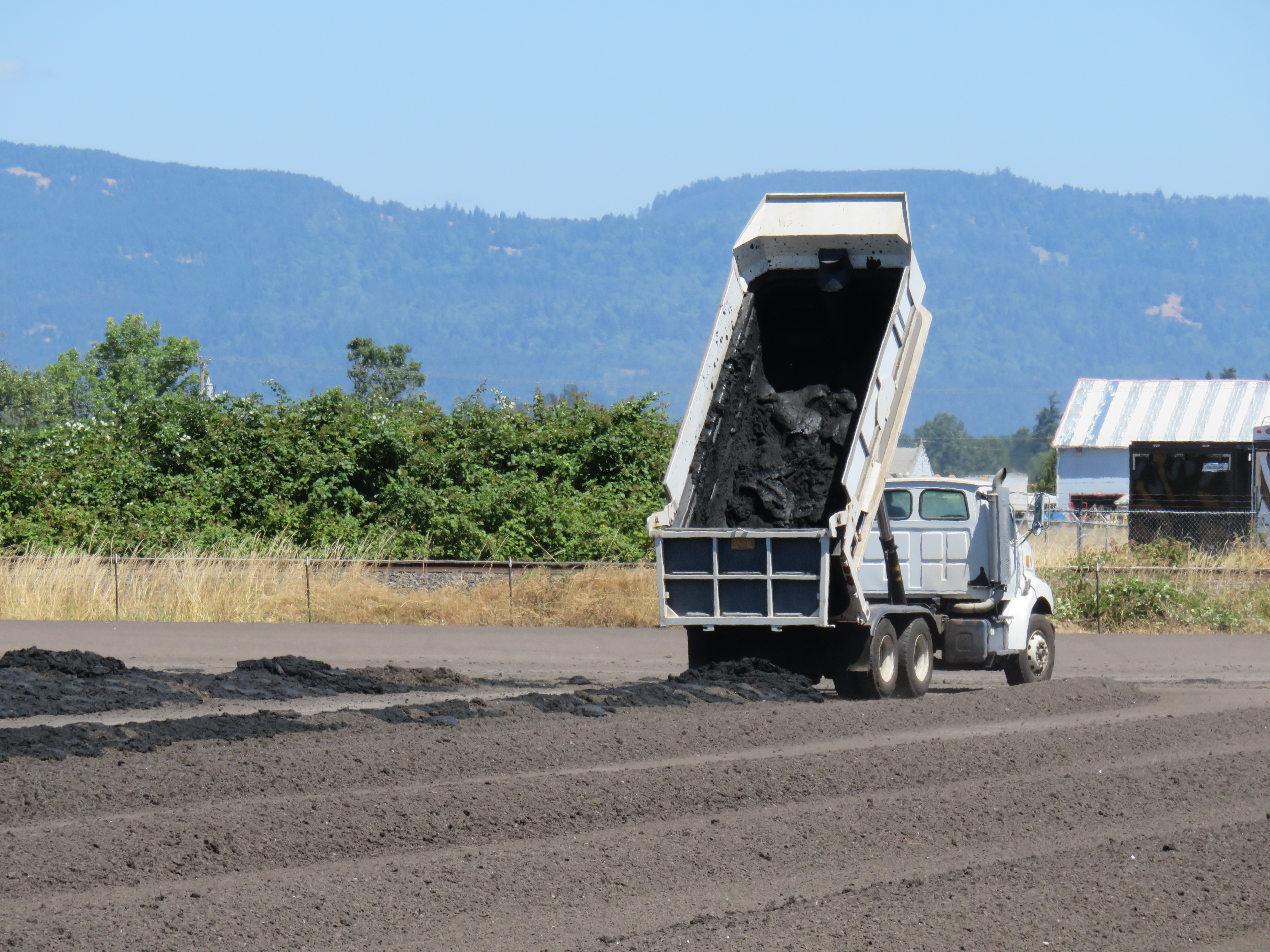 Laying out biosolids in drying beds